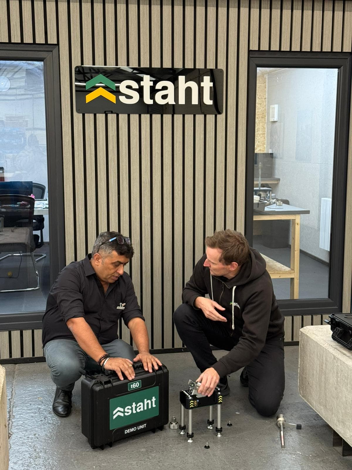 Vestok India and STAHT teams reviewing STAHT pull-testing demo unit